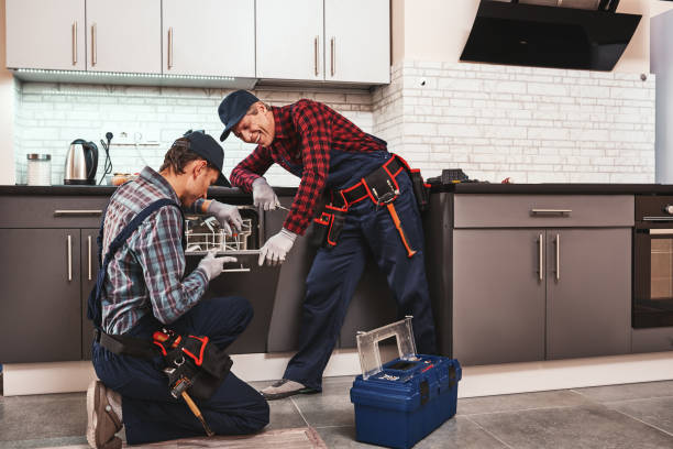 istock Take a pleasure from success. Two men technician sitting near dishwasher 1129117281