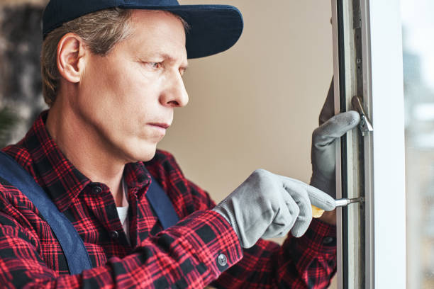 istock Master's work. Close-up of senior handyman setting new windows 1129117365