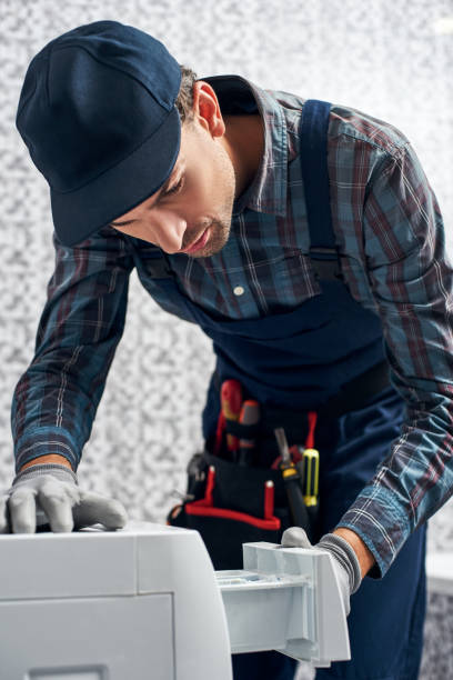 istock Inspection look. Working man plumber in bathroom checking washing mashine 1129117501