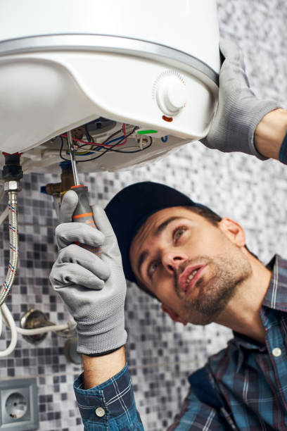 istock Set up boiler. Worker set up electric heating boiler at home bathroom 1129117519