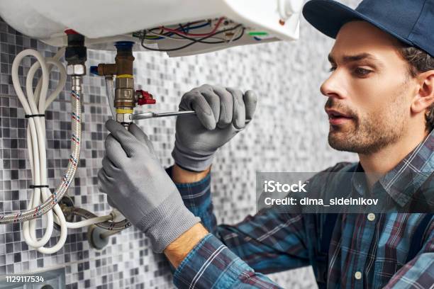 Wrench Always With You Worker Set Up Electric Heating Boiler At Home Bathroom Stock Photo - Download Image Now