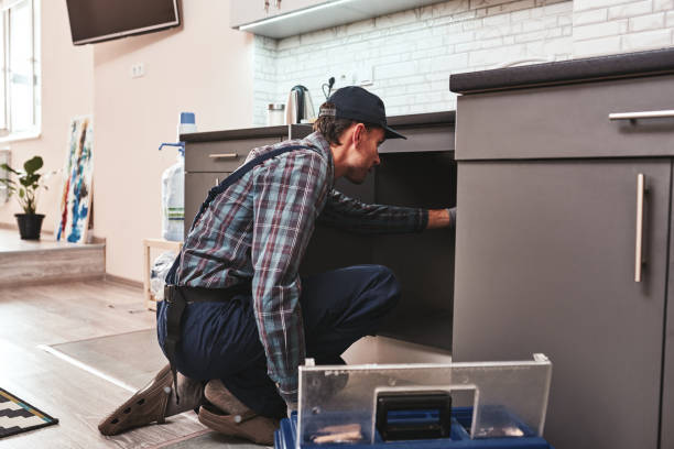 istock Checking problems. Young adult handyman repairing washbasin 1129117539