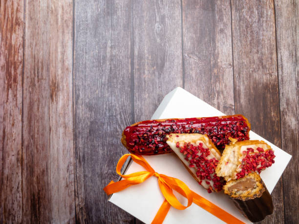 cake with cream and chocolate, ECLAIRS on wooden table