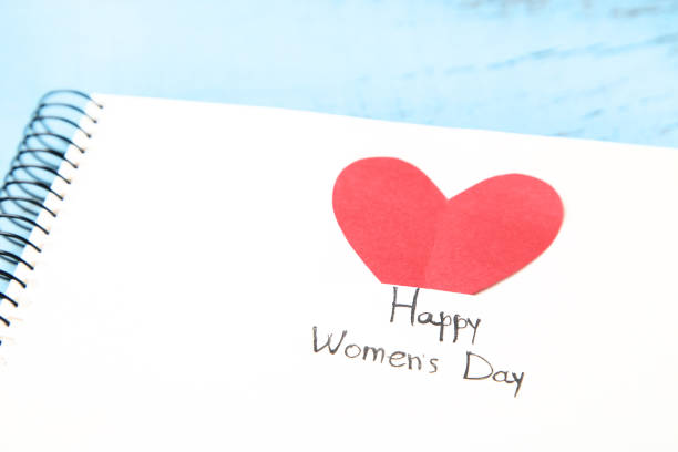 istock Text Happy Women's Day in notepad with red heart 1129118714