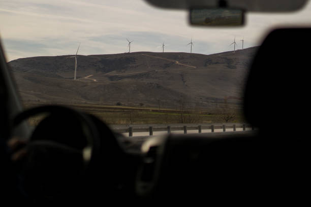 istock Wind power turbine at car 1129120822