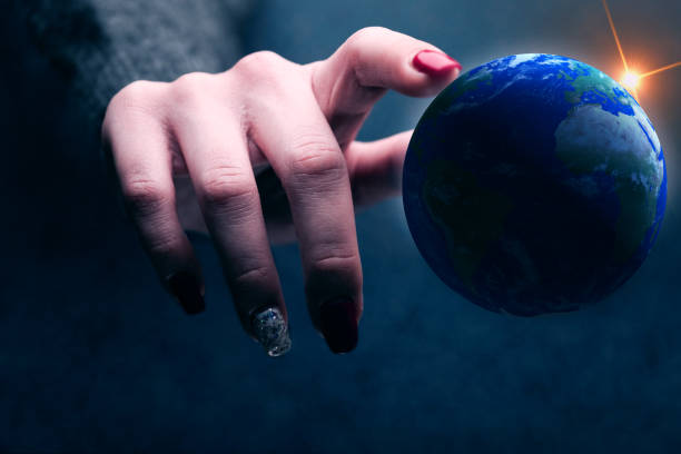 istock Woman touching planet with finger. Mixed media. 1129121397
