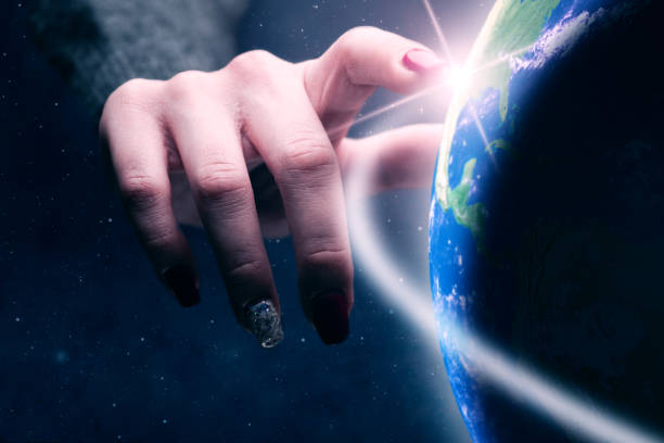 istock Woman touching planet with finger. Nebula dust in infinite space. Mixed media. 1129121408