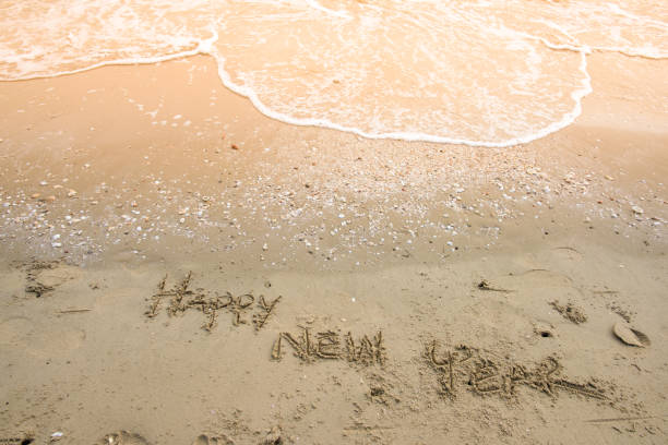 happy new year on sand background stock photo