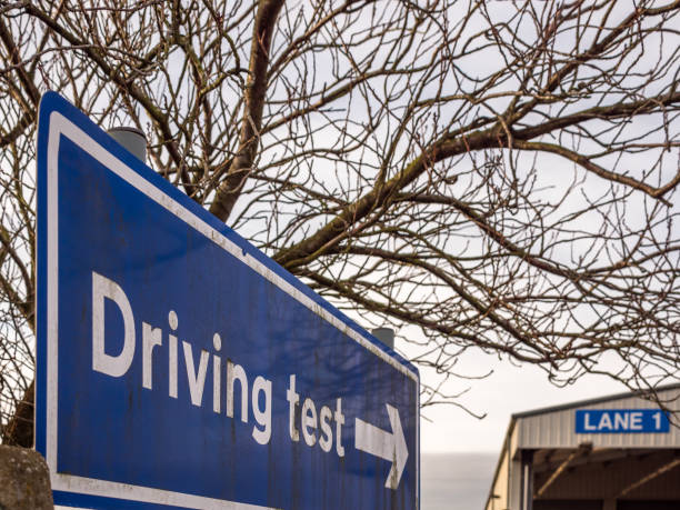 istock day view driving test blue directional sign post in england uk 1129123172