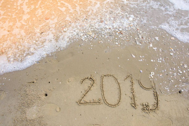 happy new year on sand background stock photo