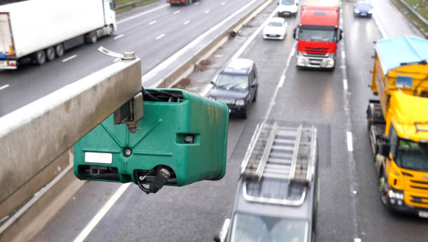 winter day view average speed traffic camera under falling snow over uk motorway - yellow city speed road imagens e fotografias de stock