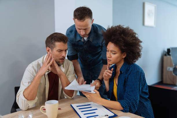istock Multi-ethnic business people brainstorming in office together 1129124039