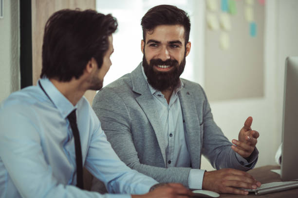 istock Two satisfied executives discussing successful project growth statistics in office 1129124163