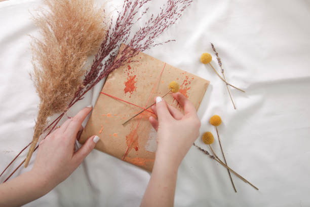 istock Woman hands gift wrapping presents 1129124440