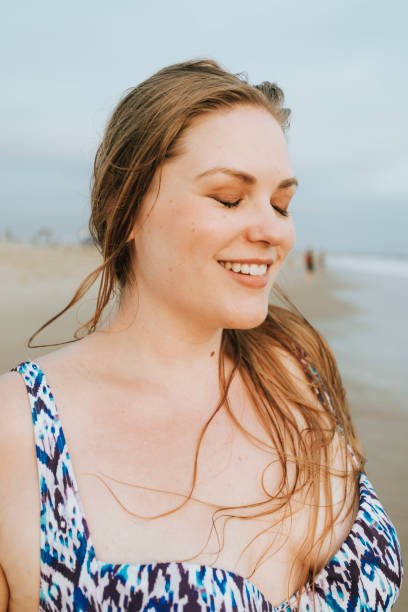 istock Confident blond plus size woman at the beach 1129125633