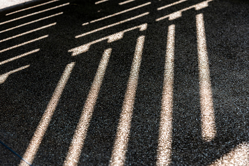 Shadows on rough surfaces with small stones Light shines through objects that cause shadows in the lines.
