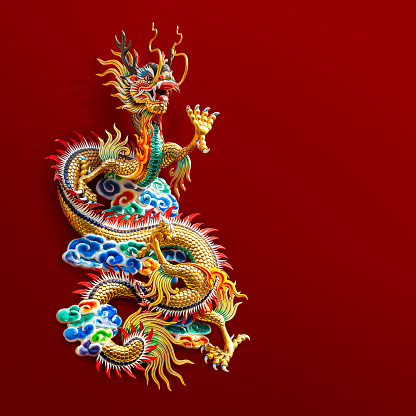 Chinese golden dragon statue for decoration in the public temple isolated on red background with clipping path