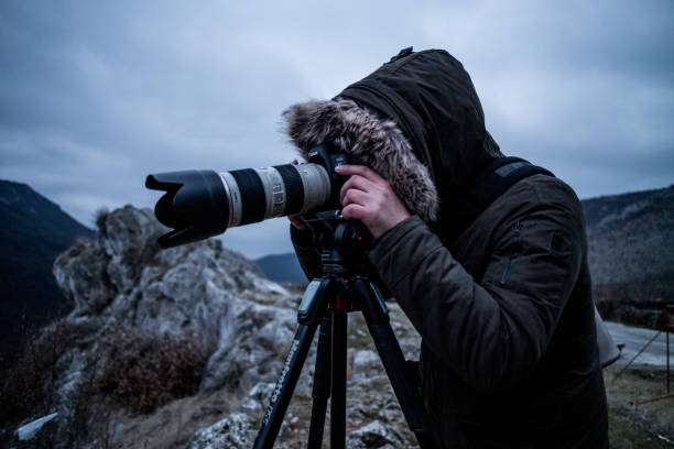 istock Photographer in the dark 1129130402