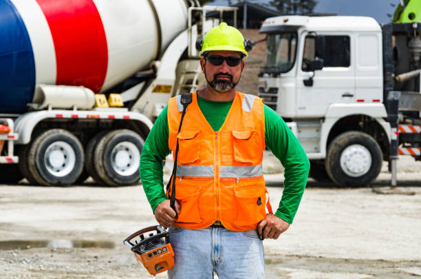 istock Concrete pump operator with remote control for boom pump truck at construction site 1129136619