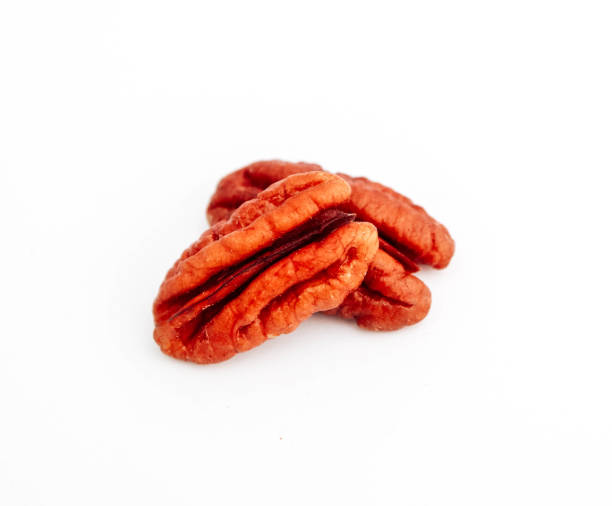 istock A group of raw pecan nuts, isolated on white background. 1129136813