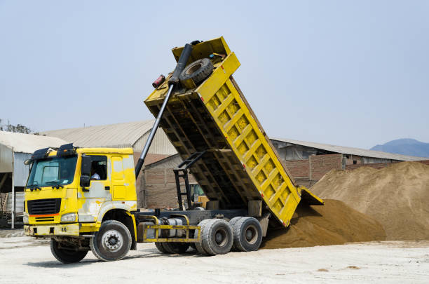 Ten yard dump truck delivering a load of dirt for a fill project