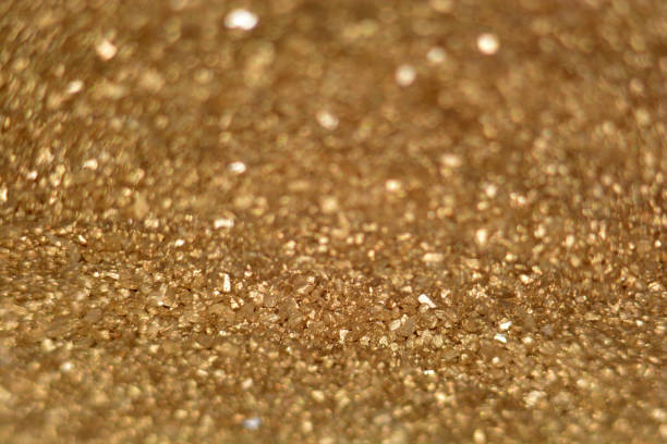 istock defocused golden glitter background with bokeh effects 1129138657