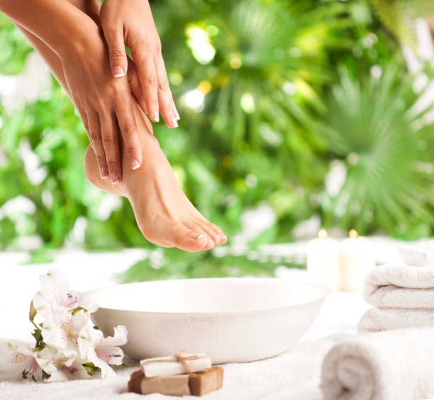 Foot spa on a tropical green leaves background stock photo