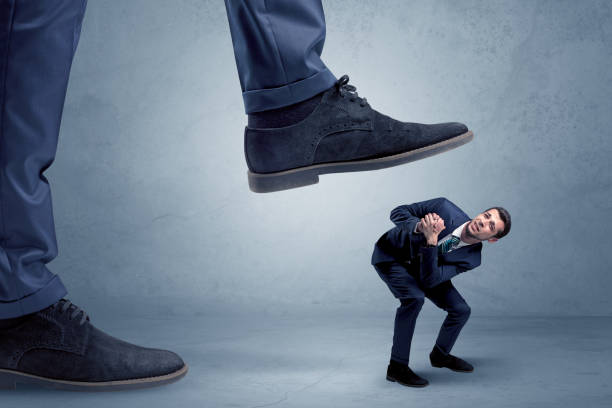 istock Trampled small businessman in suit 1129140024