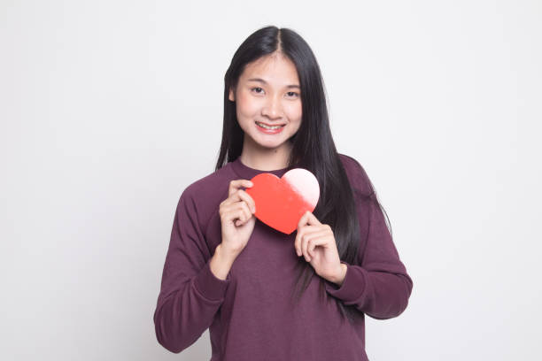 istock Asian woman with red heart. 1129141657