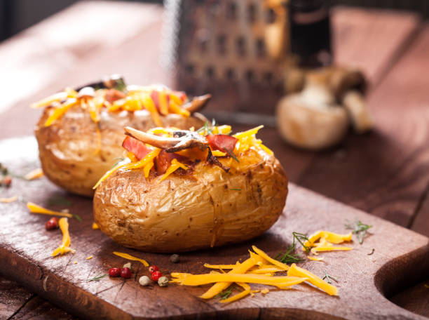 istock Baked stuffed potatoes with bacon, cheddar, mushrooms and dill 1129142878