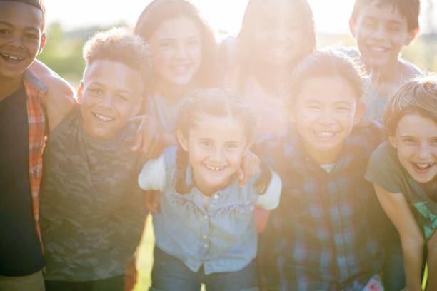 istock Diverse group of kids having fun in the park 1129143318