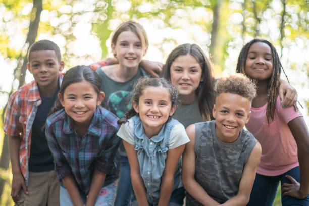 istock Diverse group of kids having fun in the park 1129143325