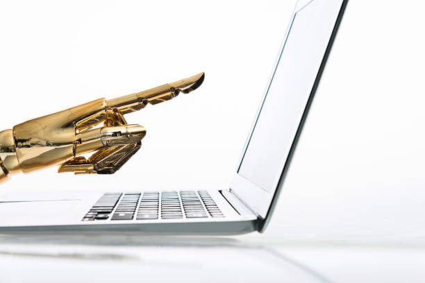 istock Robot's finger pointing to computer monitor 1129148798