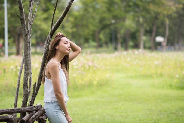 istock Woman relax in summer park 1129148993