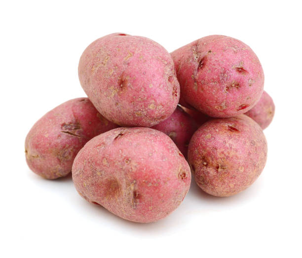istock Fresh pink potato. Isolated over white. 1129149150
