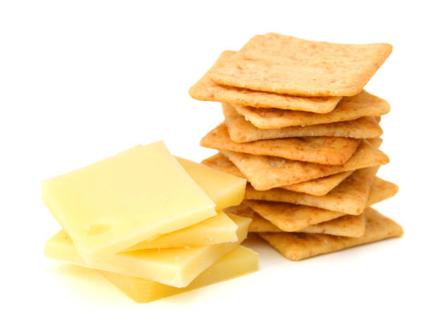 istock Delicious crackers with cheese on white background 1129149226