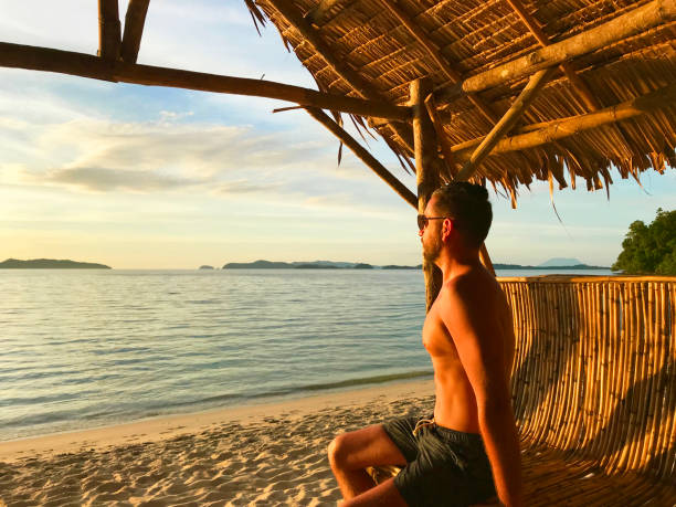 istock Young man contemplating the sunset 1129149283