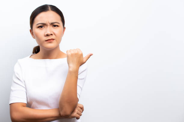 istock Angry woman standing isolated over white background 1129150013
