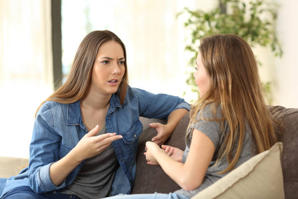 istock Serious women talking on a couch at home 1129150125