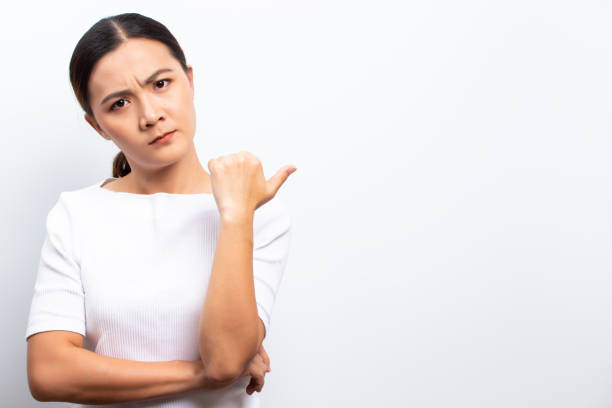 istock Angry woman standing isolated over white background 1129150130