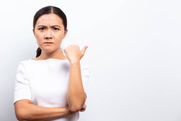 istock Angry woman standing isolated over white background 1129150282