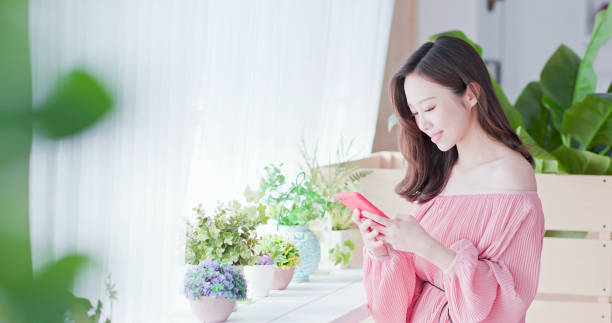 istock asian woman use smart phone 1129150473