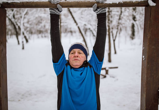 istock Senior man jogging in snow 1129150568