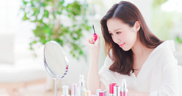 istock asian woman using mascara brush 1129150601