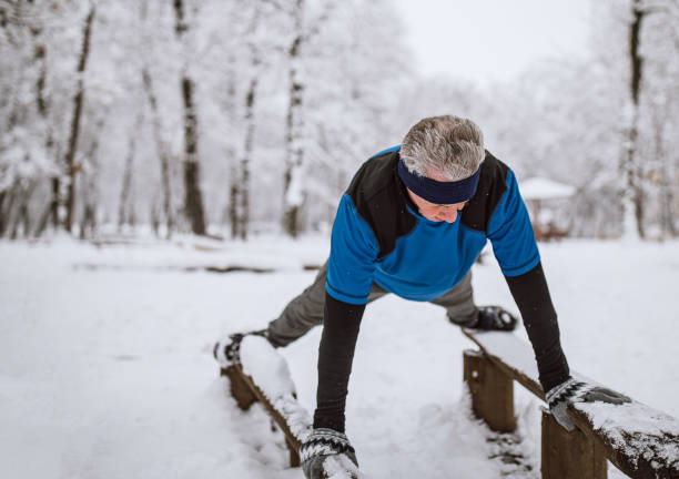 istock Senior man jogging in snow 1129150776