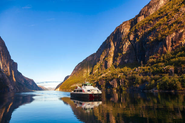 Ferry crosses Lysefjord Forsand Rogaland Norway Scandinavia Ferry crossing calm Lysefjord (Lysefjorden) arriving to Lysebotn village at the end of the fjord in Forsand municipality of Rogaland county, Norway, Scandinavia lysefjorden stock pictures, royalty-free photos & images