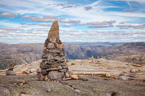 Cairn (a pile of stones) marking mountain hiking trail along the Lysefjord at Kjerag (or Kiragg) Plateau, a popular travel destination in Forsand municipality of Rogaland county, Norway, Scandinavia