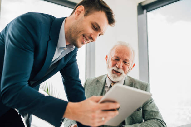 istock Business men looking at digital tablet 1129150904