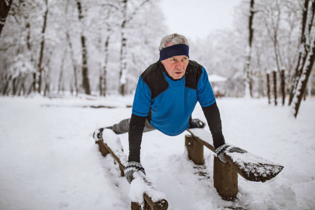 istock Senior man jogging in snow 1129150965