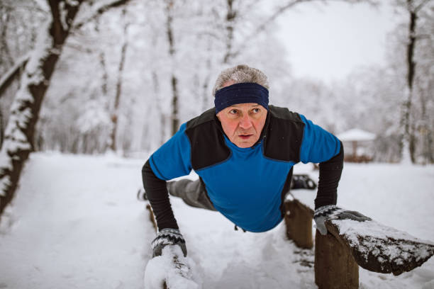 istock Senior man jogging in snow 1129151544